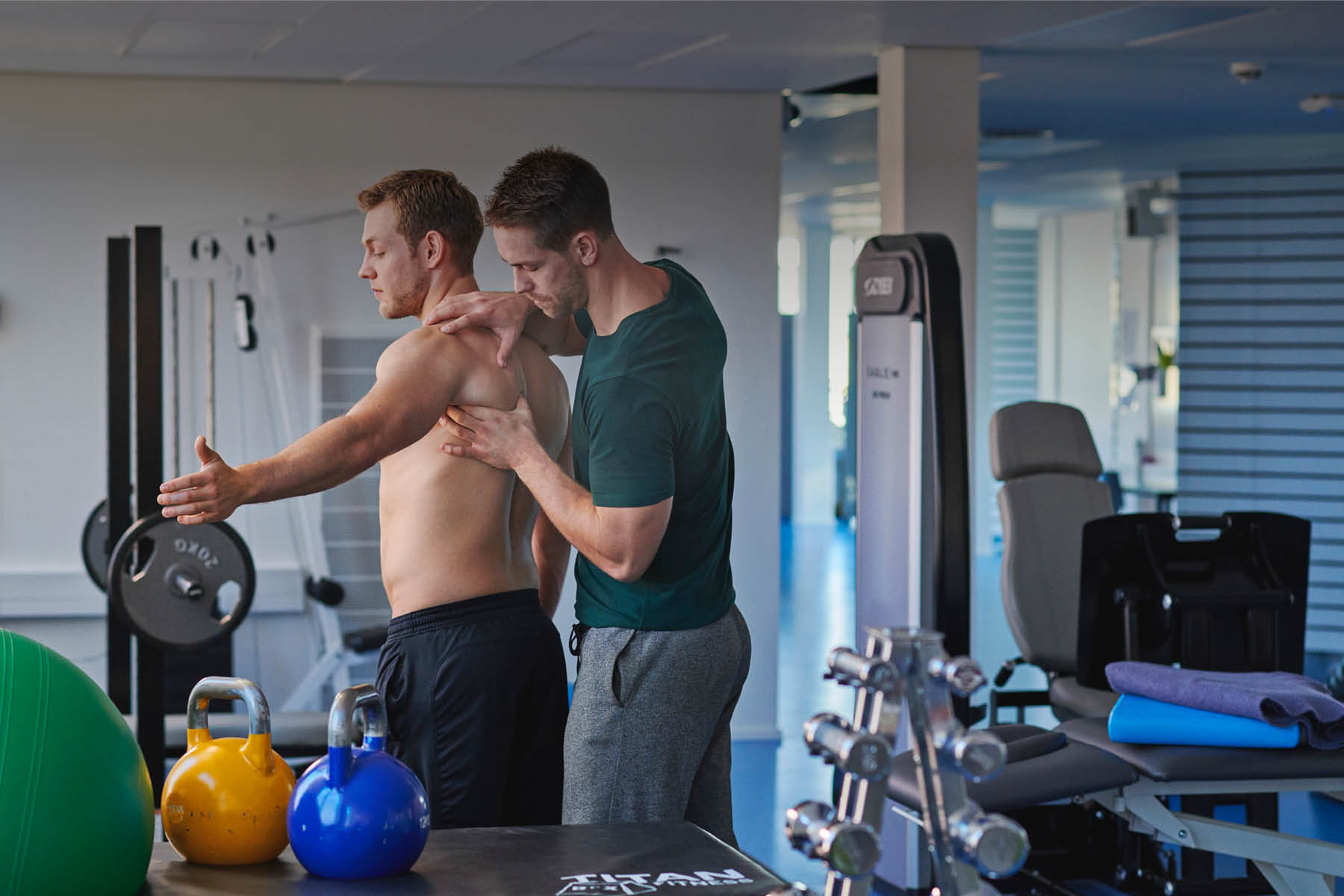 Fysioterapeutstuderende behandler en person i et træninglokale