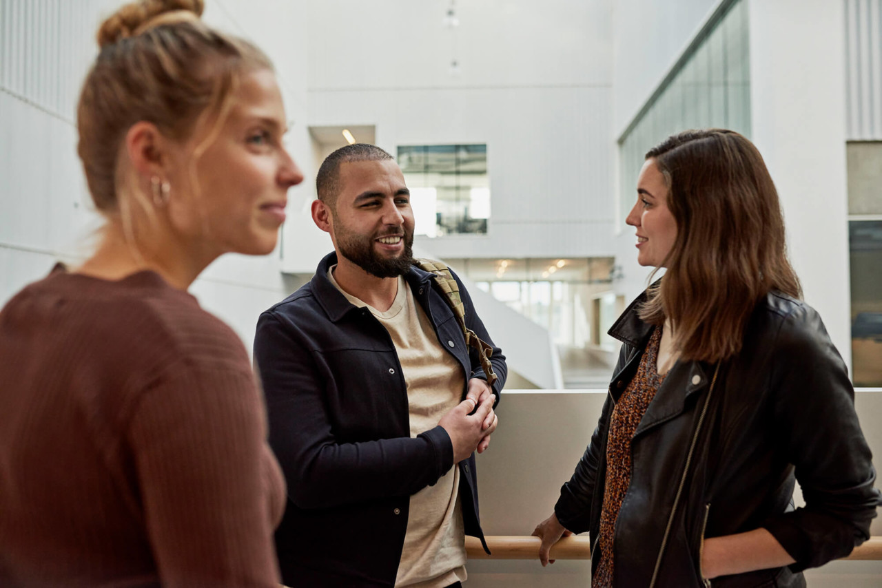 Three Teacher Education students talking at Campus Carlsberg